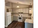 Well-lit kitchen featuring modern appliances, light-colored cabinets, and updated countertops at 132 Waiters Way Way, Youngsville, NC 27596