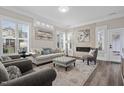 Stylish living room with plantation shutters, a modern fireplace, and sophisticated decor at 1332 Gloriosa St, Apex, NC 27523
