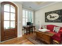 View of a home office area adjacent to the foyer with a wooden door and hardwood floors at 136 Glenpark Pl, Cary, NC 27511