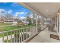 Relaxing covered front porch with rocking chairs and scenic views of the neighborhood at 1410 Briardale Ln, Durham, NC 27712