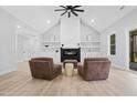 Living room featuring a fireplace and plush seating, bathed in natural light, with wood-look floors at 1429 Sagamore Dr, Louisburg, NC 27549