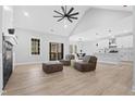 Bright living room with a ceiling fan, fireplace, and sliding doors leading to the outside deck at 1429 Sagamore Dr, Louisburg, NC 27549