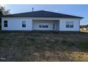 Rear exterior of the home featuring white siding and a covered patio at 1579 Pecan Drive # 29, Nashville, NC 27856