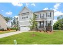 Elegant two-story home with a two-car garage and manicured lawn at 20 Bold Dr, Youngsville, NC 27596