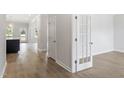 Spacious hallway featuring beautiful wood floors and natural light at 20 Bold Dr, Youngsville, NC 27596