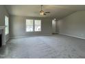 Expansive living room with cozy carpet, fireplace, and bright windows that provide an inviting atmosphere at 255 Constellation Ct, Benson, NC 27504