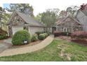 Charming stone and siding home with a well-manicured lawn and lovely landscaping at 29 Mocking Ln, Rocky Mount, NC 27804
