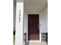Close up on the front door of a home showing the door number, stone accents, and smart lock at 3007 Honeymyrtle Ln, Durham, NC 27703