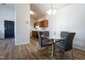 Inviting dining area with hardwood floors, a modern table, and a view into the contemporary kitchen at 3031 Winston Dr # Apt 302, Burlington, NC 27215