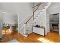 Bright foyer featuring hardwood floors, a staircase, and a glimpse into the living and dining areas at 3416 Cottonwood Dr, Durham, NC 27707