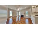 Spacious living room featuring hardwood floors, a cozy fireplace, and abundant natural light at 3501 Kensett Way, Raleigh, NC 27616