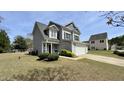Two story home with a manicured yard and attached two-car garage at 404 Braxman Ln, Holly Springs, NC 27540