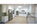 Spacious kitchen featuring white cabinetry, stainless steel appliances, and lots of counter space at 410 N Currie Dr, Sanford, NC 27330