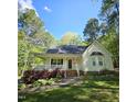 Inviting home with a classic front porch, bay window, and beautifully landscaped yard, all nestled among mature trees at 4116 Tall Pine Dr, Franklinton, NC 27525