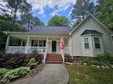 Charming single-Gathering home featuring a cozy front porch and beautiful landscaping at 4116 Tall Pine Dr, Franklinton, NC 27525