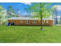 Spacious backyard featuring well-kept lawn and brick exterior at 412 Winterlocken Dr, Sanford, NC 27330