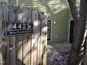 Welcoming front entrance with address plaque and rustic wooden gate to this charming home at 4425 Moss Garden Path, Raleigh, NC 27616