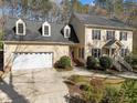 Traditional home with a two-car garage, manicured lawn and walkway leading to the front door at 5122 Berkeley St, Raleigh, NC 27612