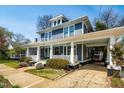Charming blue two-story home with a cozy covered porch and manicured yard at 620 Wills Forest St, Raleigh, NC 27605