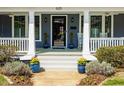 Inviting front porch featuring stylish plants, classic columns, and a well-maintained entrance at 620 Wills Forest St, Raleigh, NC 27605