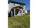 View of a backyard with green grass, landscaping, and a covered patio at 628 Brittany Ct, Durham, NC 27703