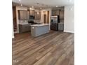 This kitchen has grey cabinets, an island, and stainless appliances, perfect for cooking and entertaining at 628 Brittany Ct, Durham, NC 27703