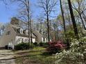 Exterior view of home featuring dormer windows, siding, and a surrounding landscape with trees and shrubs at 63 Tally Ho Dr, Selma, NC 27576