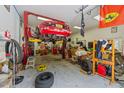 Large garage space with red car lift at 63 Tally Ho Dr, Selma, NC 27576