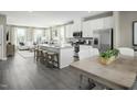 Open-concept kitchen featuring white cabinetry, stainless steel appliances, a kitchen island and an eat-in dining area at 713 Tambor Rd, Durham, NC 27713