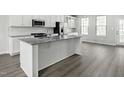 Bright kitchen showcasing granite countertops, stainless steel appliances, and an island with bar seating at 713 Tambor Rd, Durham, NC 27713