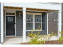 Inviting front entrance with white columns, dark trim, and meticulous landscaping creates a warm welcome at 813 James J Freeland Dr, Hillsborough, NC 27278