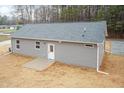 Backyard view of a single-story house with gray siding and a concrete patio at 100 Gates St, Roxboro, NC 27573