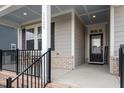 Inviting front porch with a covered seating area, decorative railing, and stylish front door at 1020 Topland Ct, Morrisville, NC 27560