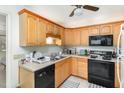 Functional kitchen featuring wooden cabinets, black appliances, and tiled flooring at 105 Elizabeth St, Chapel Hill, NC 27514