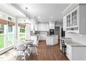 Bright, eat-in kitchen featuring white cabinetry, granite countertops and stainless steel appliances at 109 S Fern Abbey Ln, Cary, NC 27518