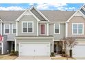 Charming townhome featuring a well-maintained front yard, attached garage, and inviting facade with interesting architectural details at 109 Shale Creek Dr, Durham, NC 27703