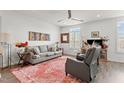 Bright living room with gray sofa, accent rug, and ample natural light at 1094 Ambergate Sta, Apex, NC 27502