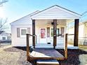 Inviting single-story home with a cozy, covered porch featuring appealing dark wooden pillars and well-kept front yard at 1220 Garner Rd, Raleigh, NC 27610