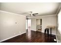A spacious living room with ceiling fan, hardwood floors and neutral-colored walls, creating a calm and inviting atmosphere at 1220 Garner Rd, Raleigh, NC 27610