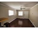 Bright living room with a ceiling fan, hardwood floors, and two windows letting in natural light at 1220 Garner Rd, Raleigh, NC 27610