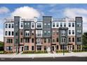 New townhome exterior showcases brick and grey facade with modern black-framed windows at 1245 S Blount Street # 201, Raleigh, NC 27601