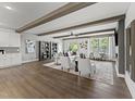 Open living room features wood floors, beamed ceilings, neutral decor and seamless flow at 1245 S Blount Street # 201, Raleigh, NC 27601