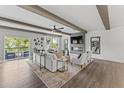 Living area boasts beamed ceilings, wood floors, fireplace, and access to an outdoor balcony at 1245 S Blount Street # 201, Raleigh, NC 27601