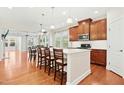 Open-concept kitchen featuring a large center island, modern appliances, and seamless flow into the dining and living areas at 1247 Magic Hollow Rd, Durham, NC 27713