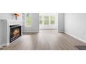Bright living room featuring a fireplace and large windows with natural light at 1300 Hillbrow Ln # 204, Raleigh, NC 27615