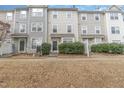 Attractive townhome exteriors with neutral siding and neatly manicured bushes at 1311 Canyon Rock Ct # 105, Raleigh, NC 27610