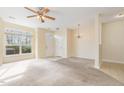 Bright living room featuring neutral paint, carpet flooring, and a ceiling fan at 1311 Canyon Rock Ct # 105, Raleigh, NC 27610