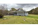 Quaint single-story home with a screened porch and a well-maintained lawn at 1324 Buffalo Rd, Smithfield, NC 27577