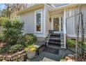 Inviting front entrance with a small bench and beautiful landscaping at 140 Hedgerow, Pittsboro, NC 27312