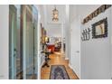 Bright hallway with hardwood floors and decorative wall decor at 140 Hedgerow, Pittsboro, NC 27312
